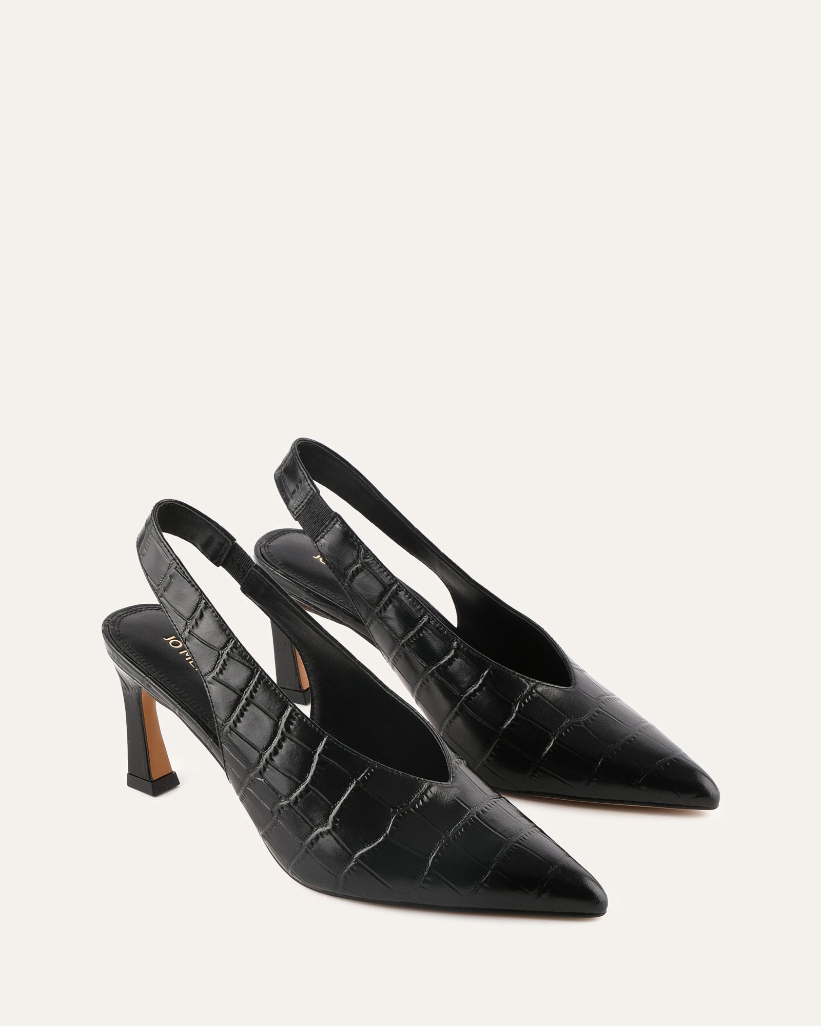Black crocodile-patterned slingback shoe on a light gray background