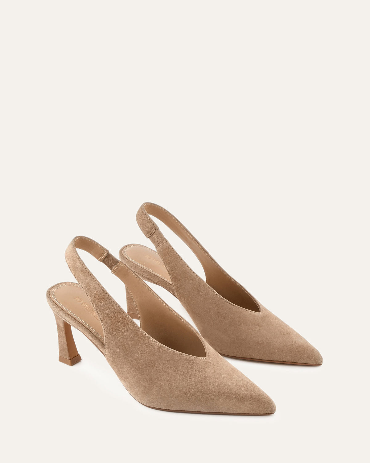 Pair of beige high-heeled slingback shoes on a light gray background