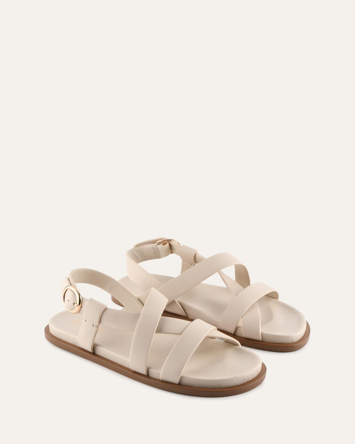 Pair of beige sandals on a white background