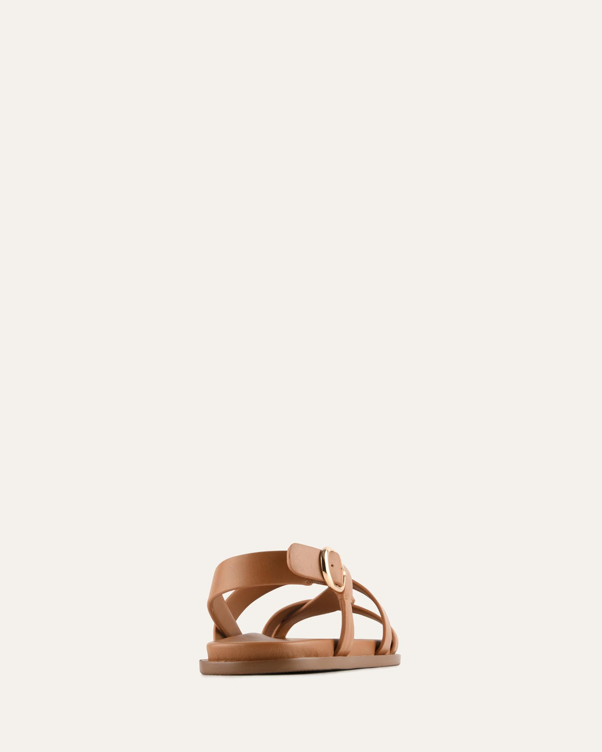Tan sandal on a light beige background