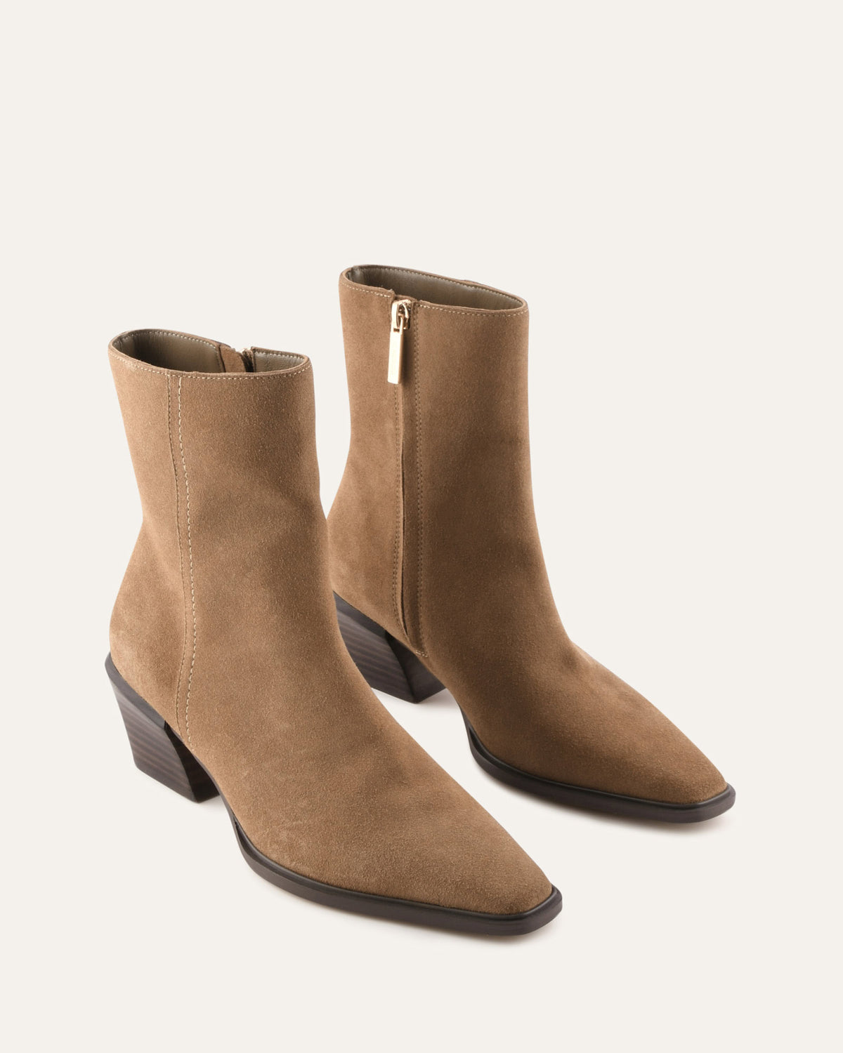 Pair of brown suede ankle boots on a white background