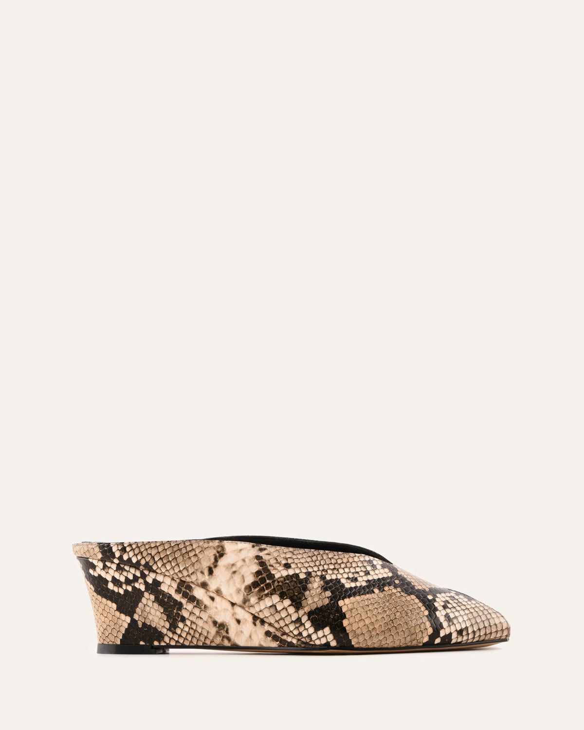 Snake print flat shoe on a light beige background