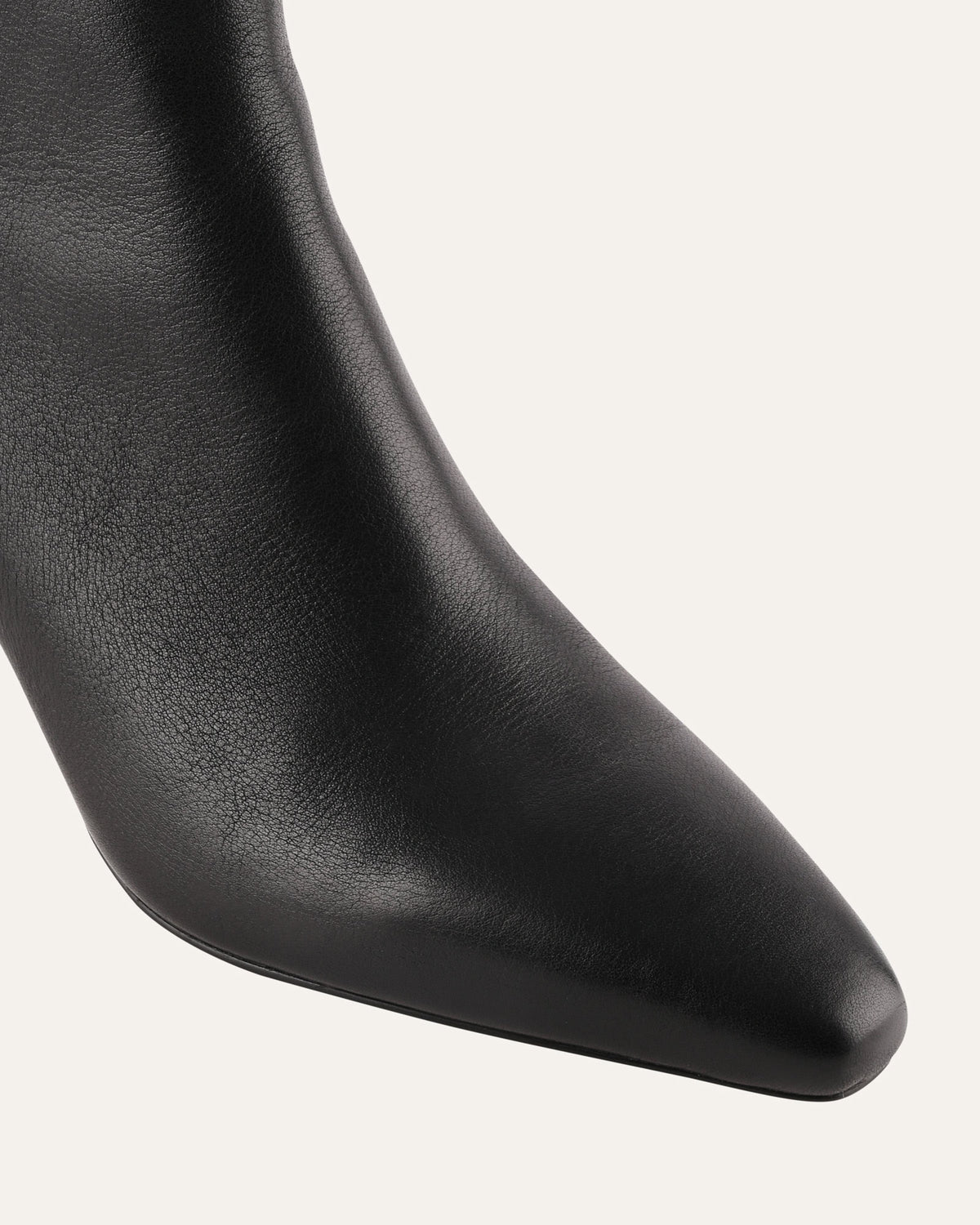 Close-up of a black leather boot on a white background