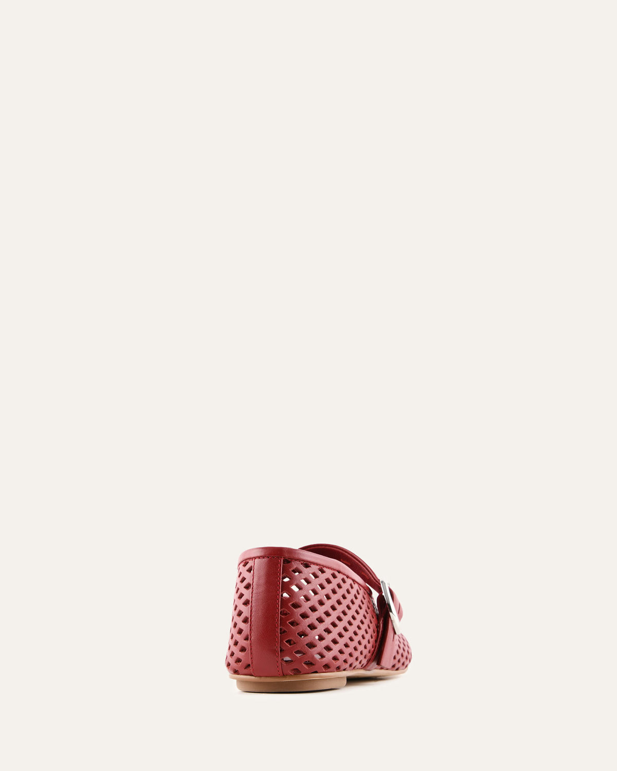 Red perforated shoe on a white background