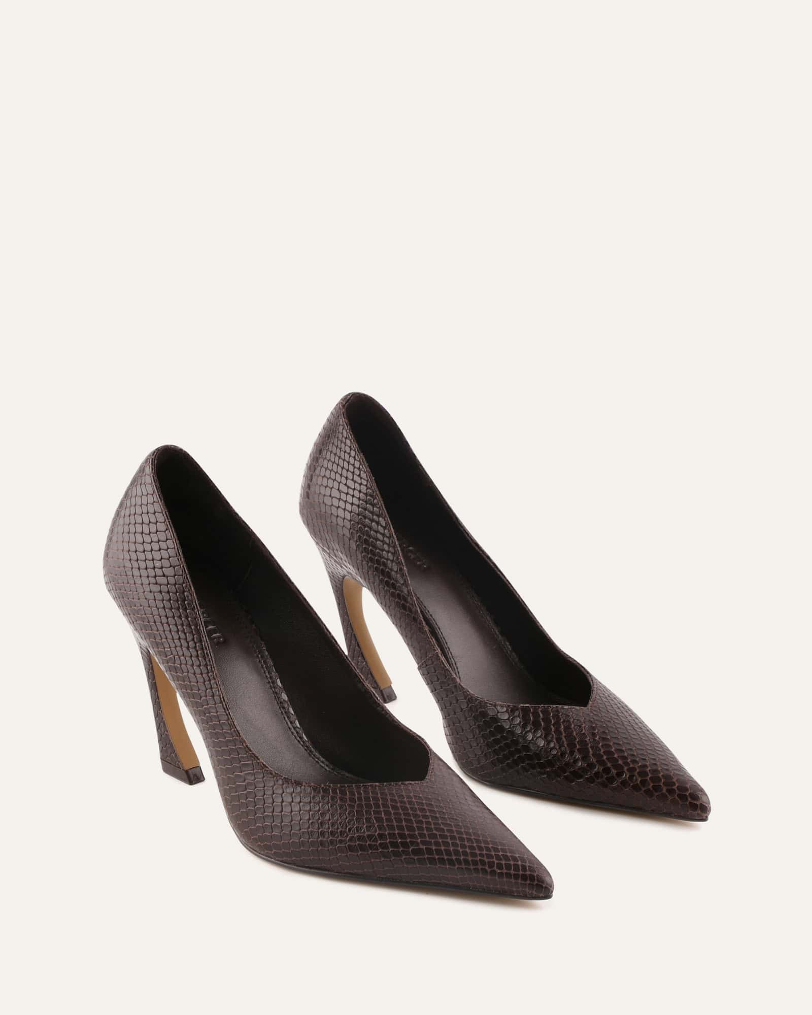 Black high-heeled shoe with a pointed toe on a white background