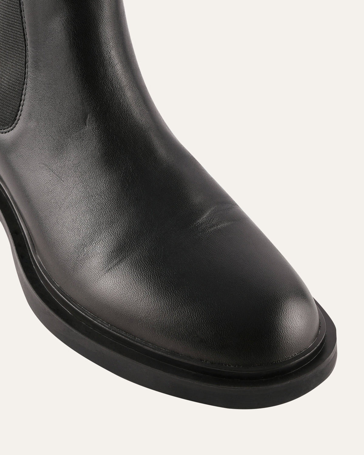 Black leather boot on a white background