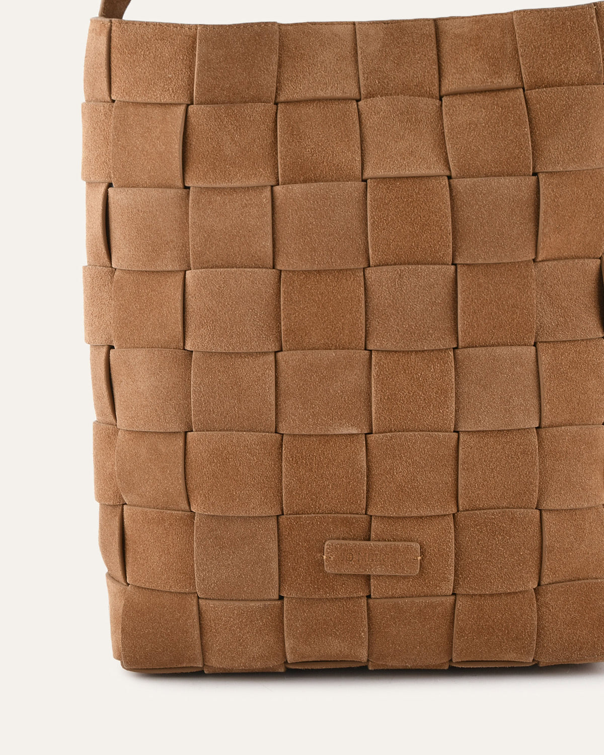Close-up of a brown woven handbag on a white background