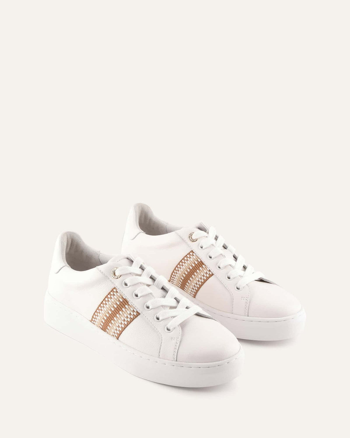 White sneakers with gold accents on a light gray background