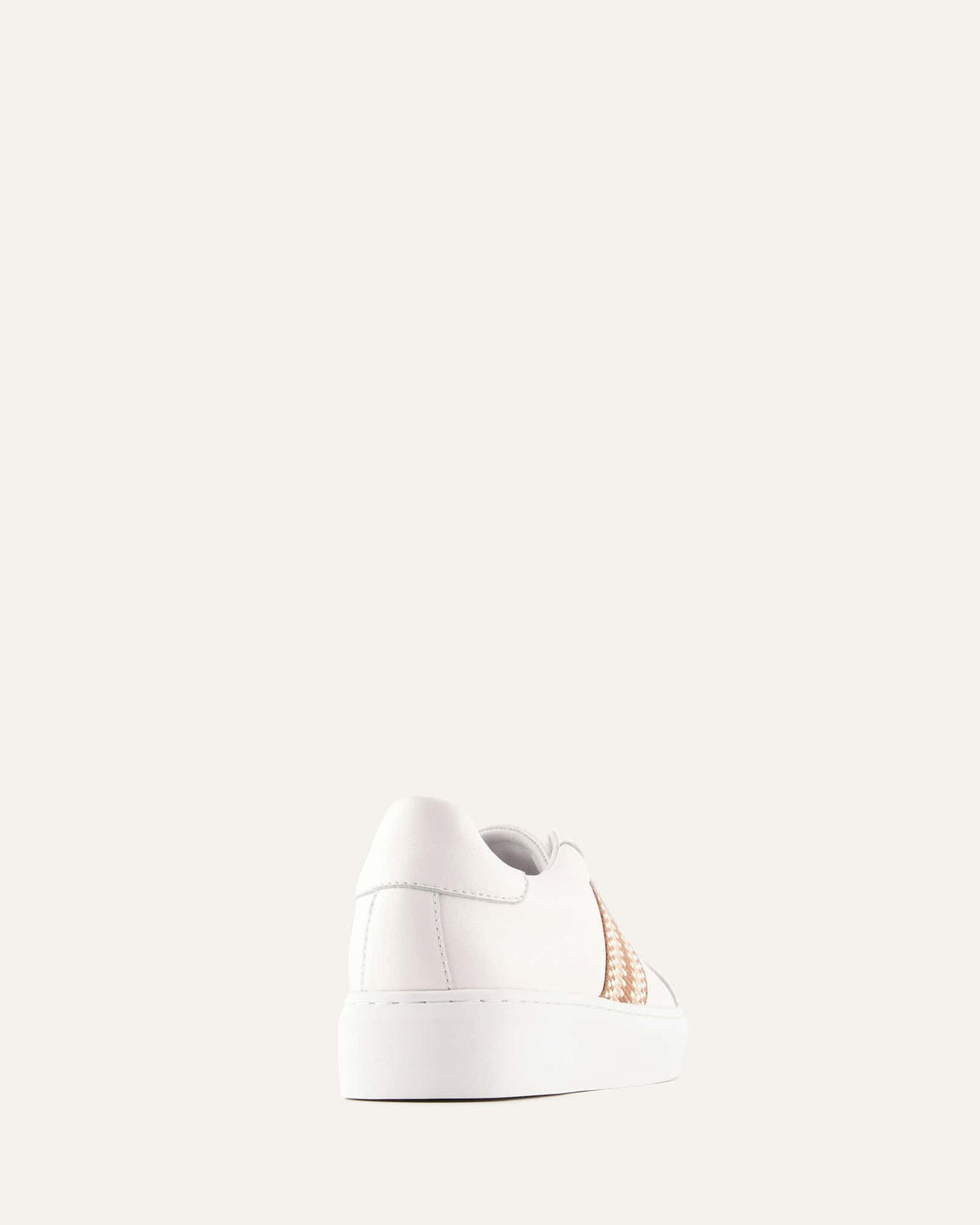 White sneaker with a small logo on a light gray background