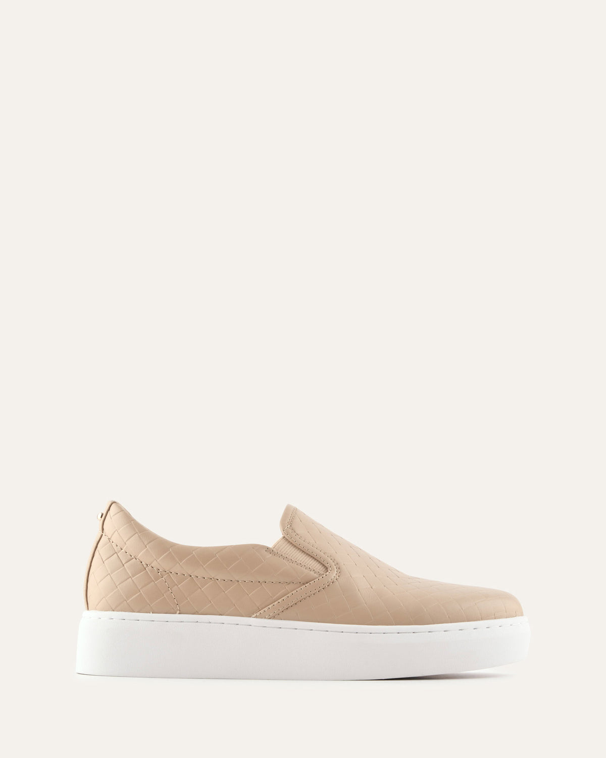 Beige slip-on sneaker with a white sole on a light beige background