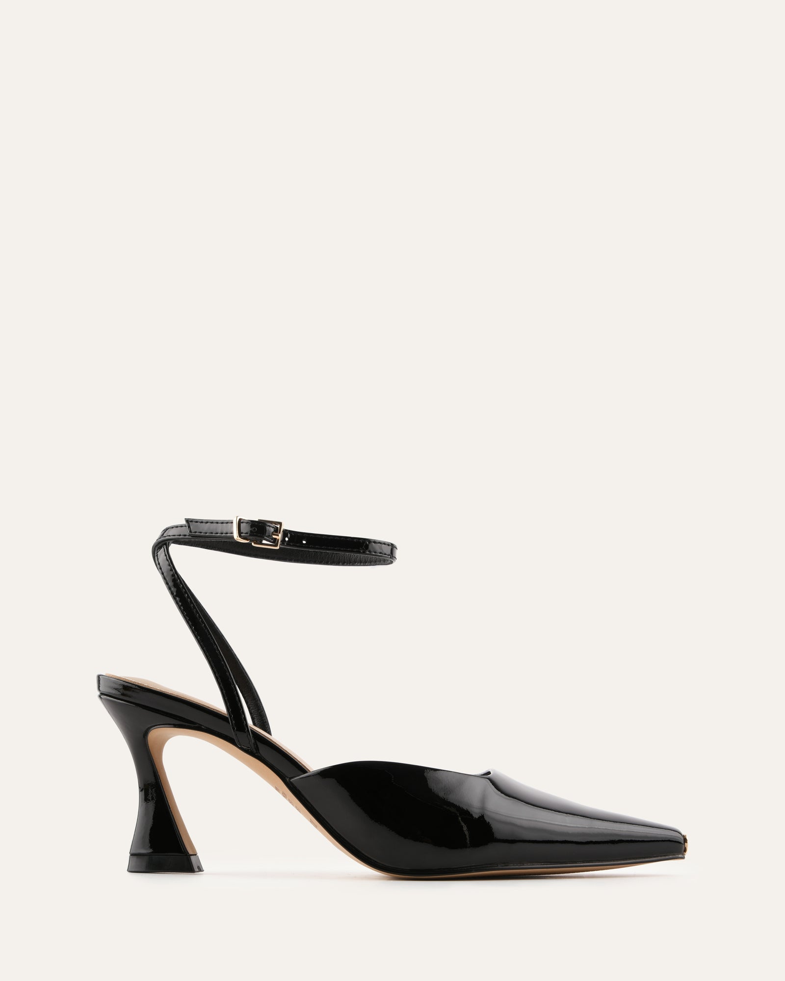 Black high-heeled shoe with a strap on a light gray background