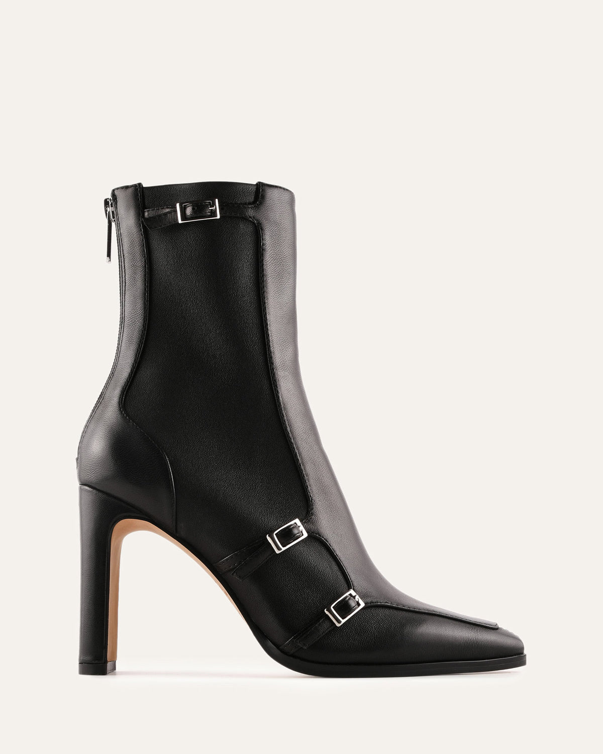 Black leather ankle boot with buckles on a light gray background
