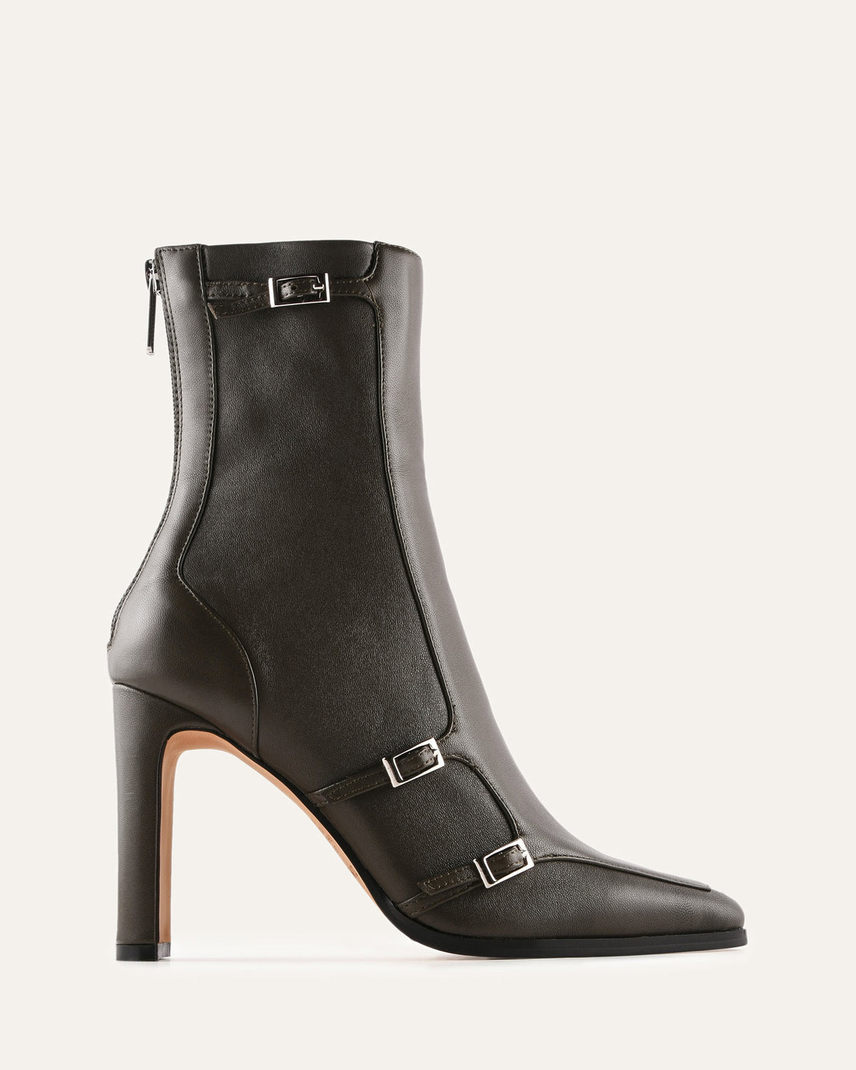Green ankle boot with buckles on a light gray background
