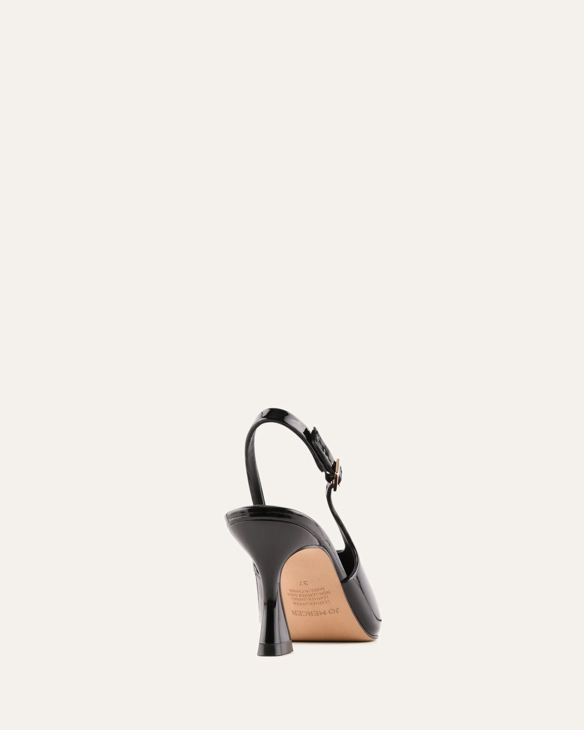 Black high-heeled shoe on a light beige background