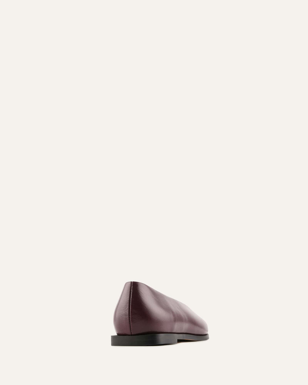 Mauve leather flat shoe on a light beige background