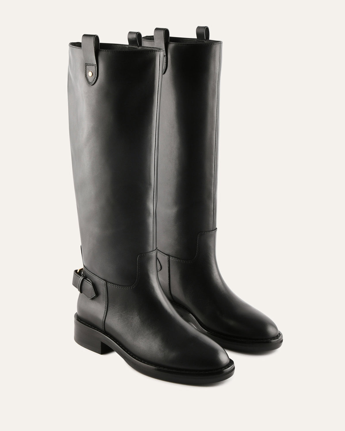 Pair of black knee-high boots on a light gray background