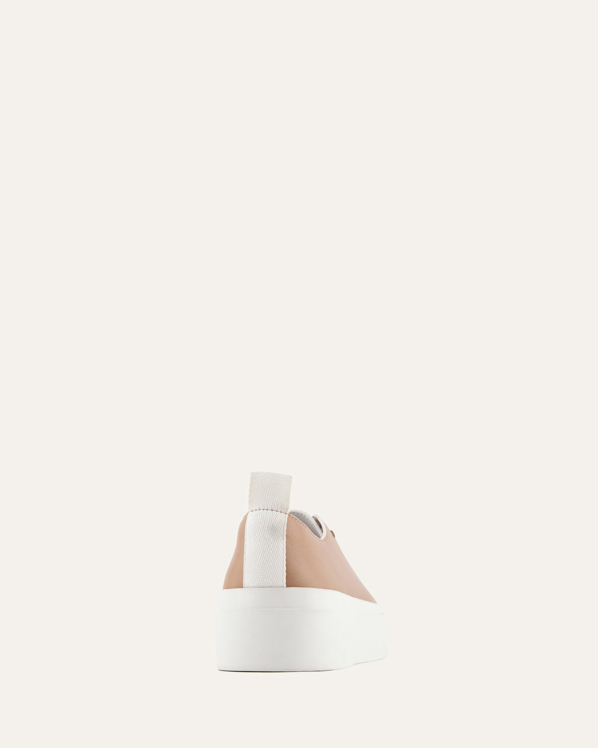 White cylindrical container with a beige cap on a light gray background