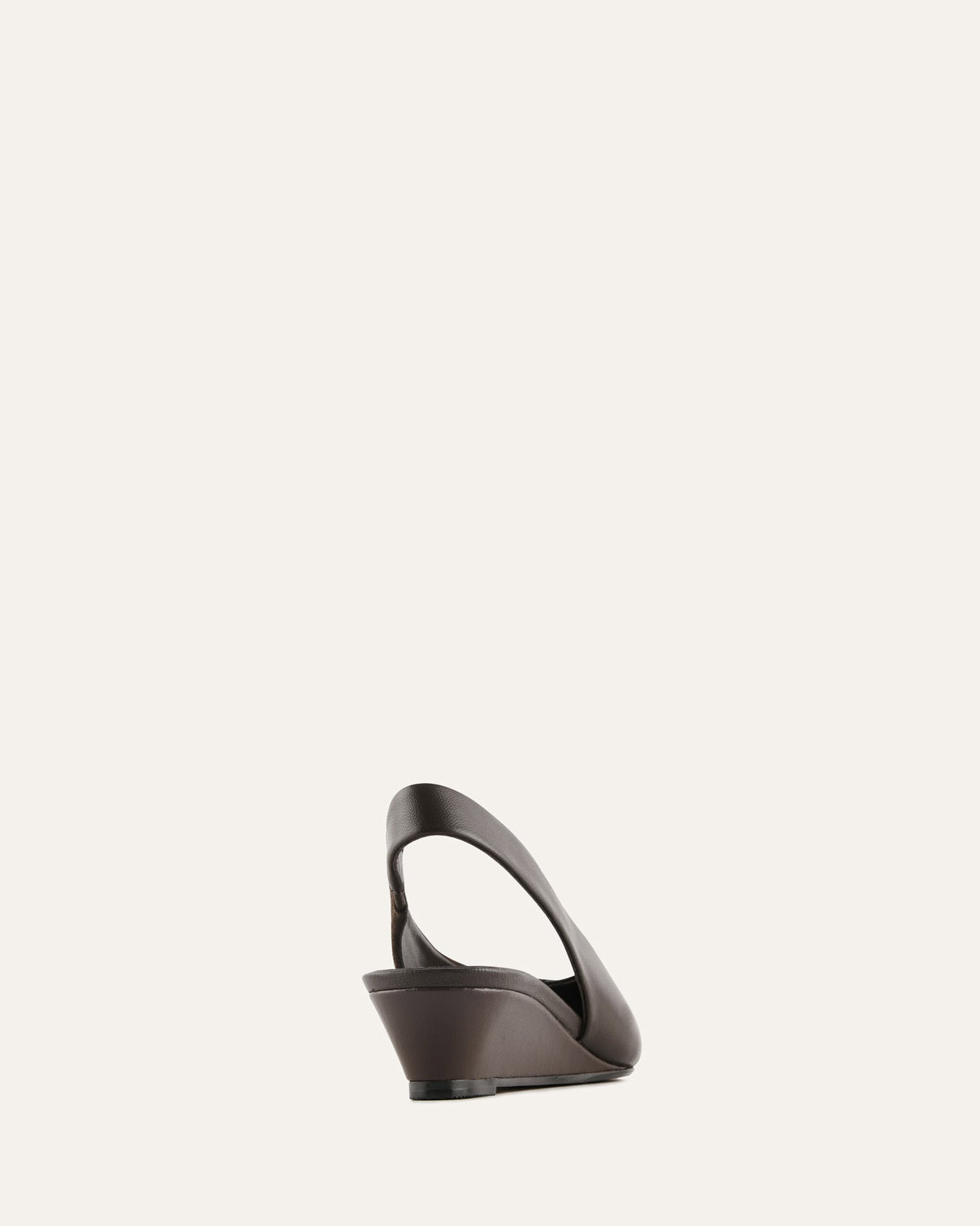 Black wedge sandal on a light beige background