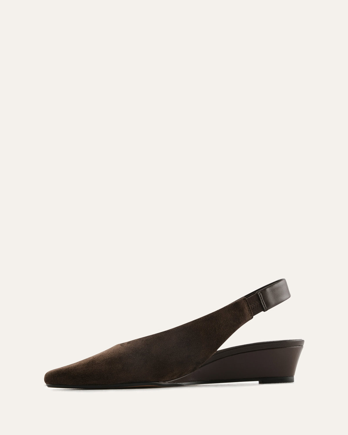Brown wedge shoe on a light gray background