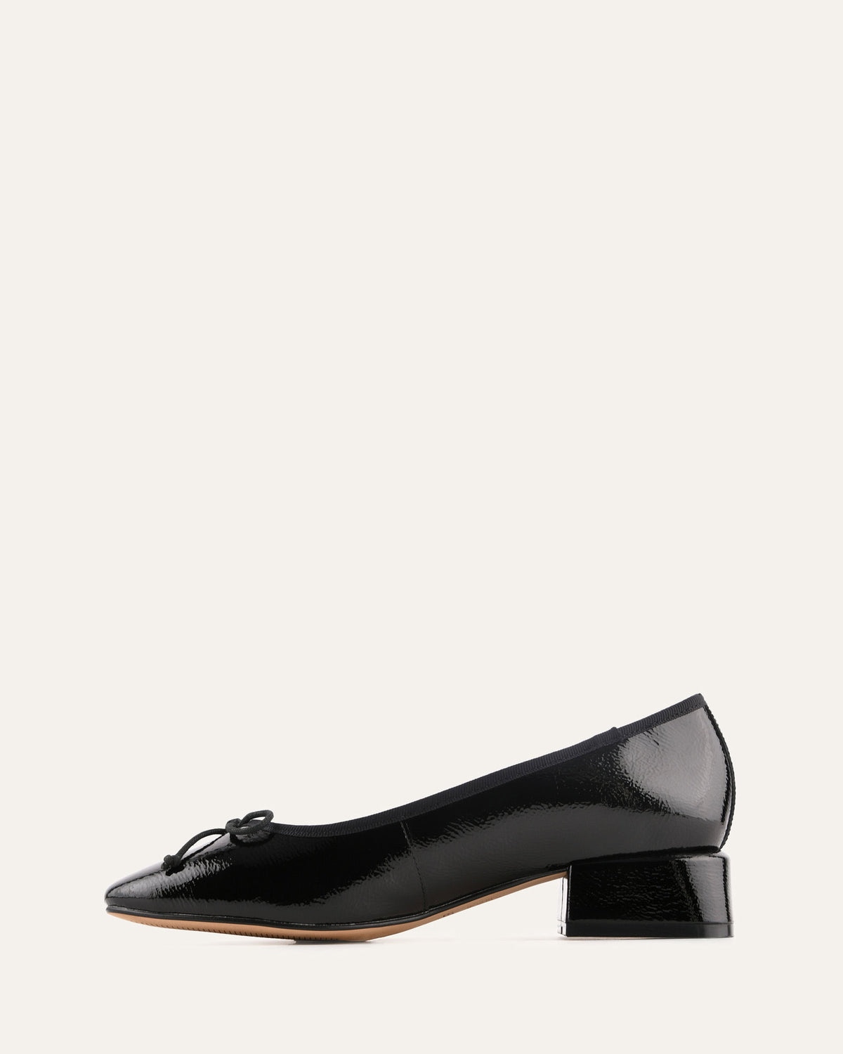 Black patent leather shoe on a white background
