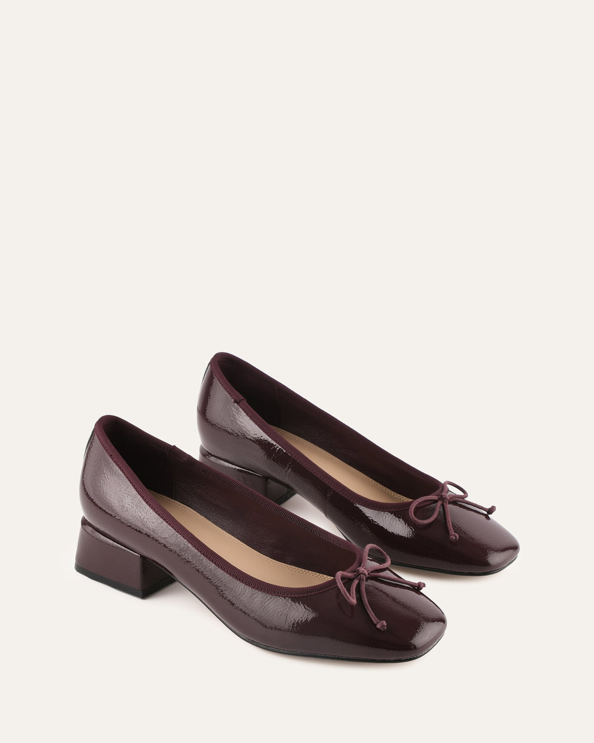 Pair of brown shoes with a bow on a white background