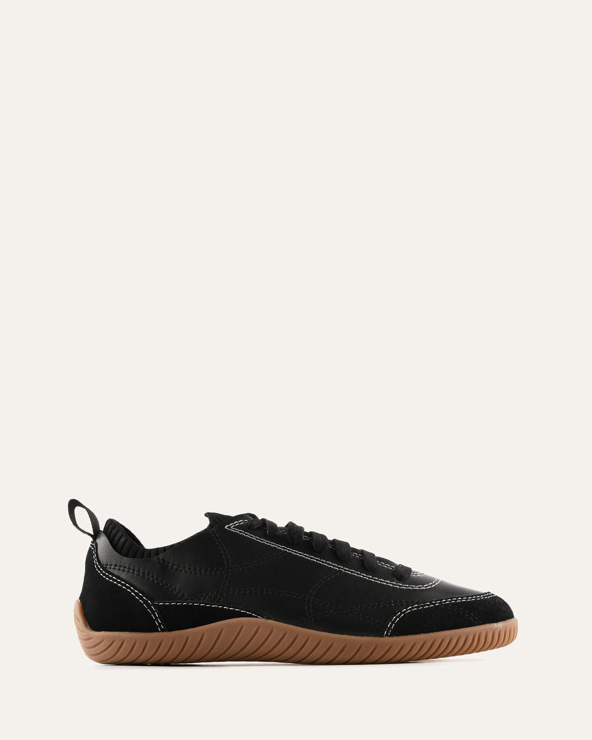 Black sneaker with brown sole on a white background