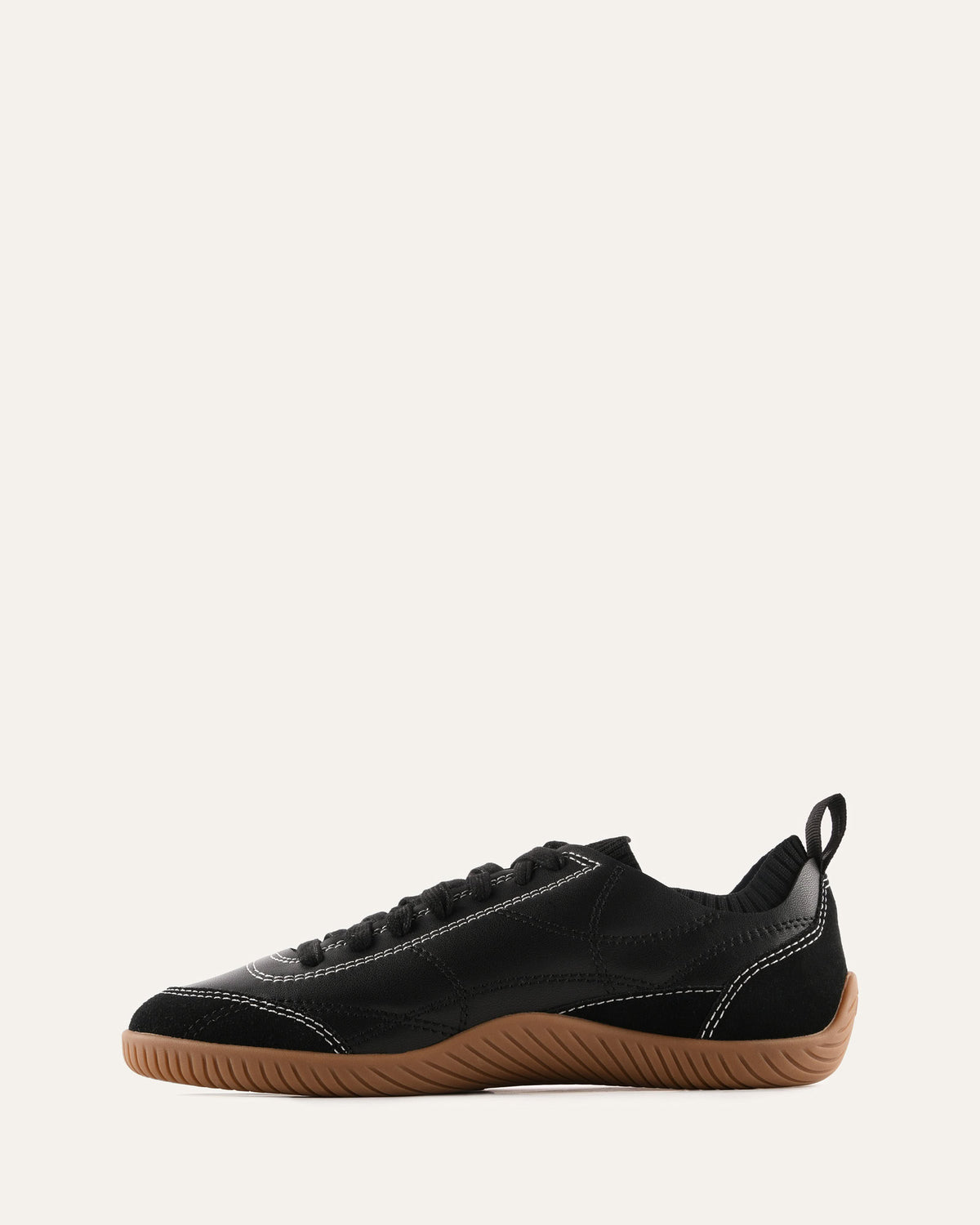 Black sneaker with brown sole on a white background