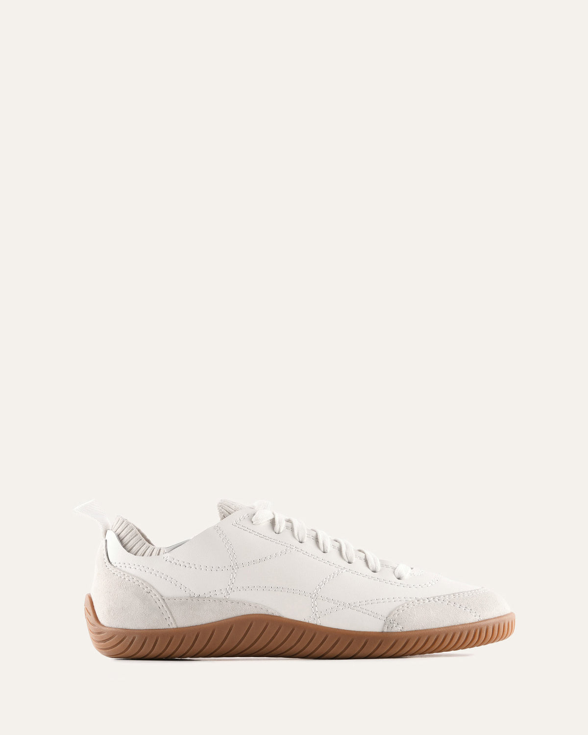 White sneaker with brown sole on a white background