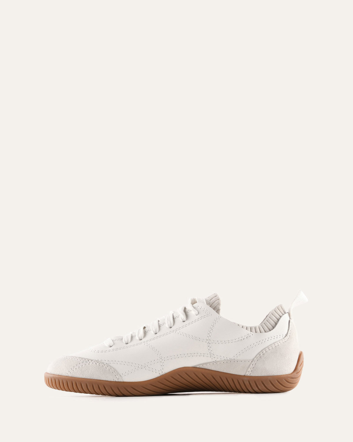 White sneaker with brown sole on a white background