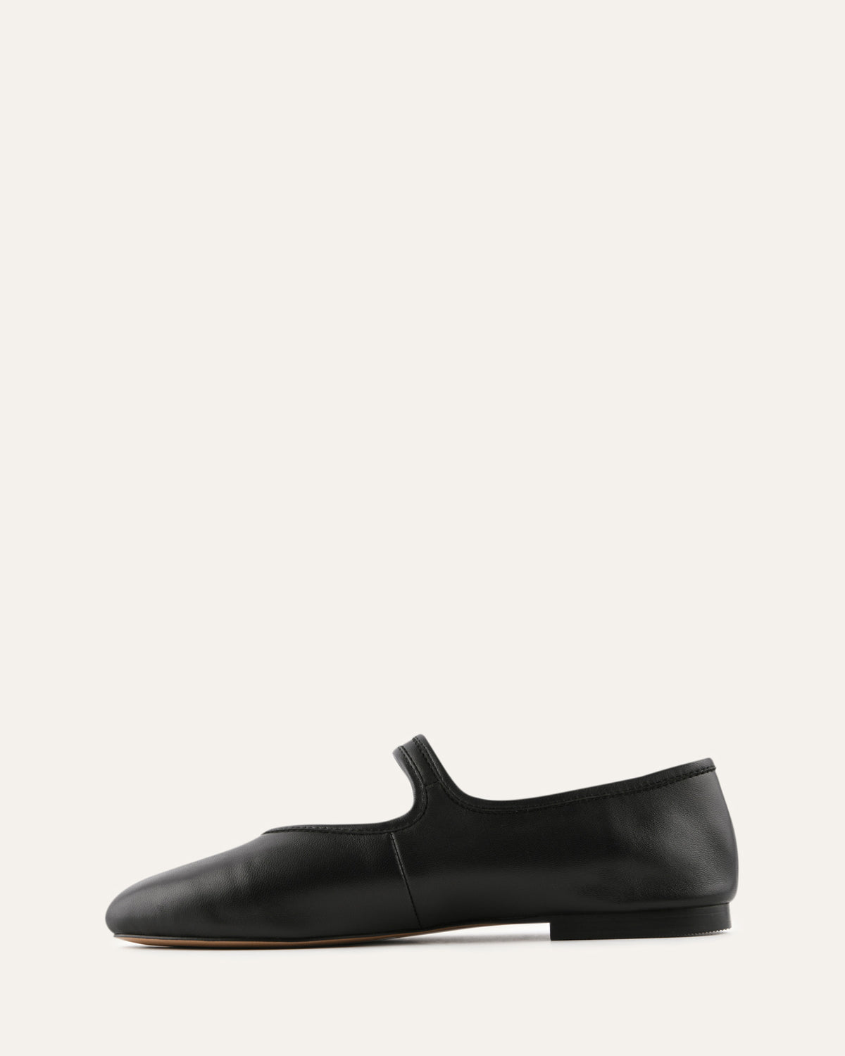 Black leather flat shoe on a white background