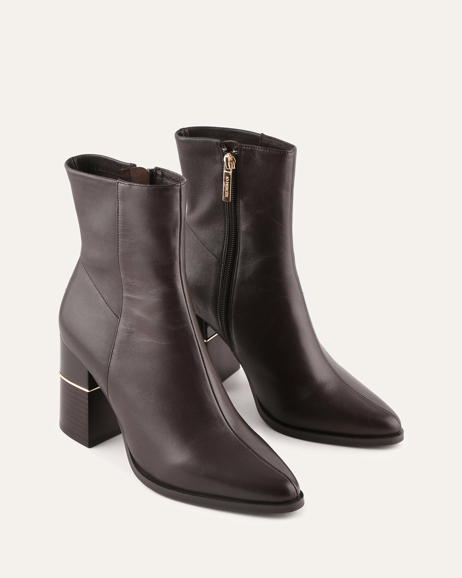 Black ankle boot with a block heel on a light gray background