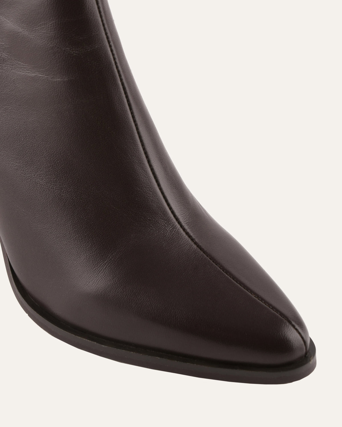 Close-up of a brown leather boot on a white background