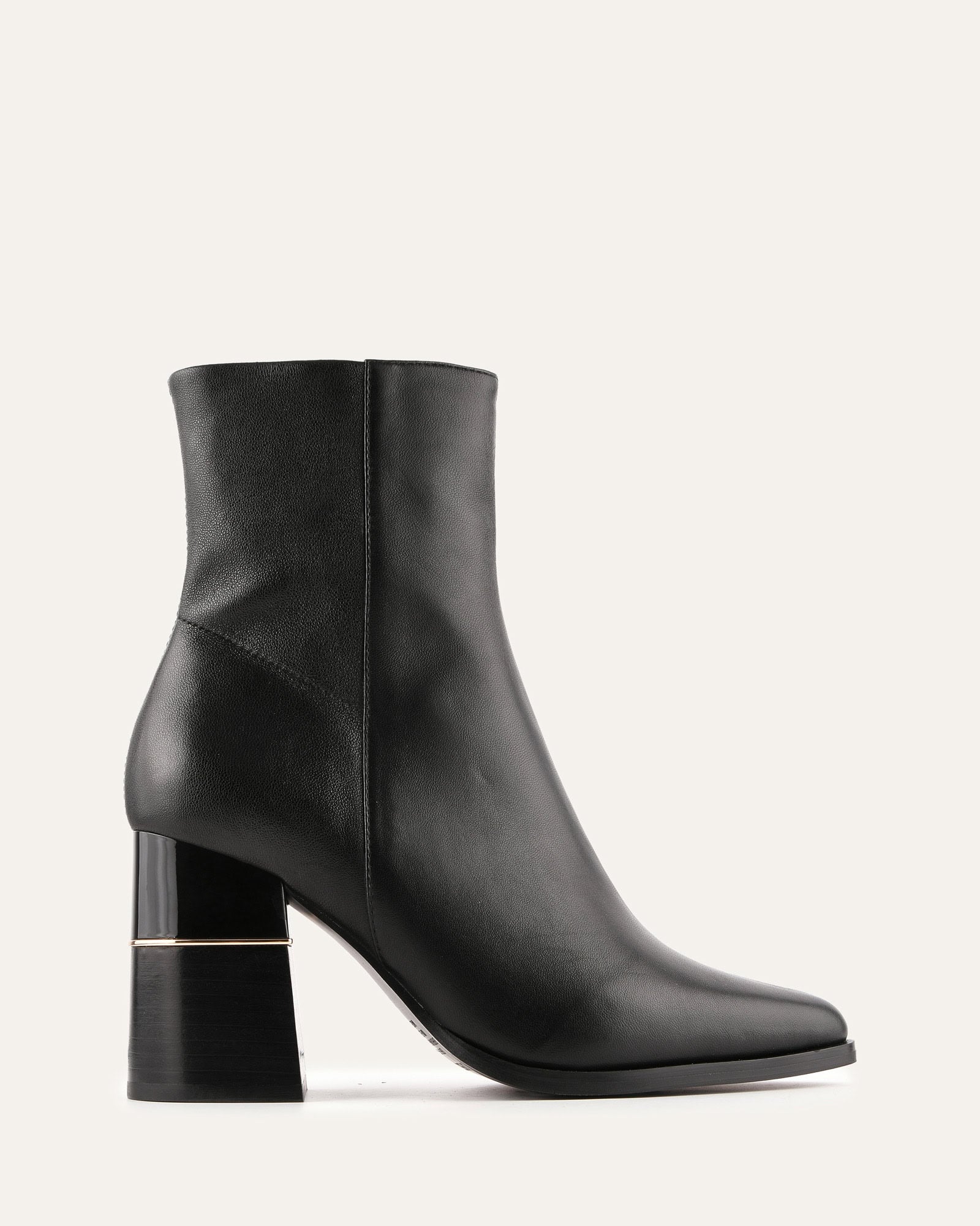 Black ankle boot with a block heel on a light gray background