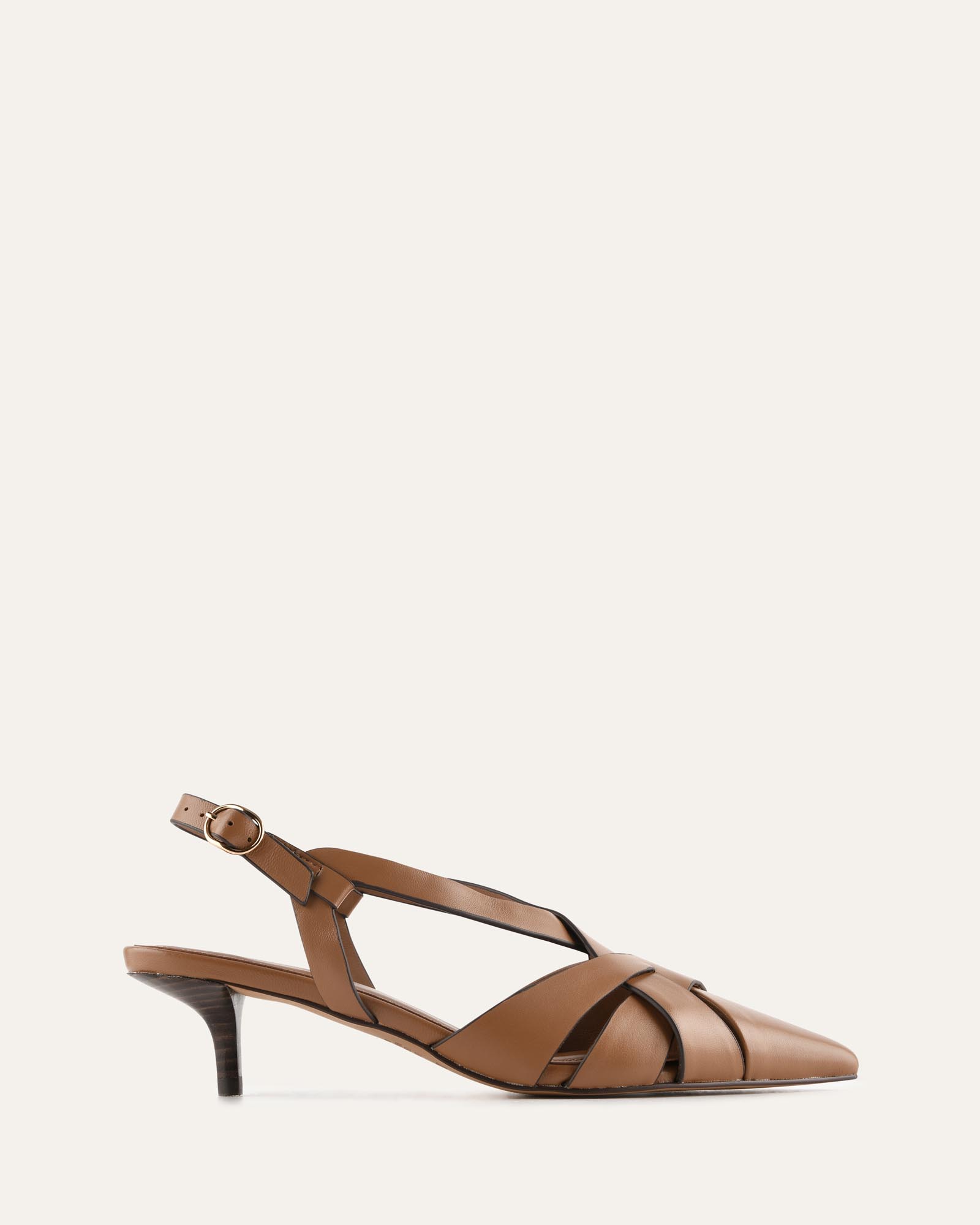 A single brown leather slingback sandal with a pointed toe, crisscrossing straps, and a low kitten heel, shown in profile against a solid off-white background.