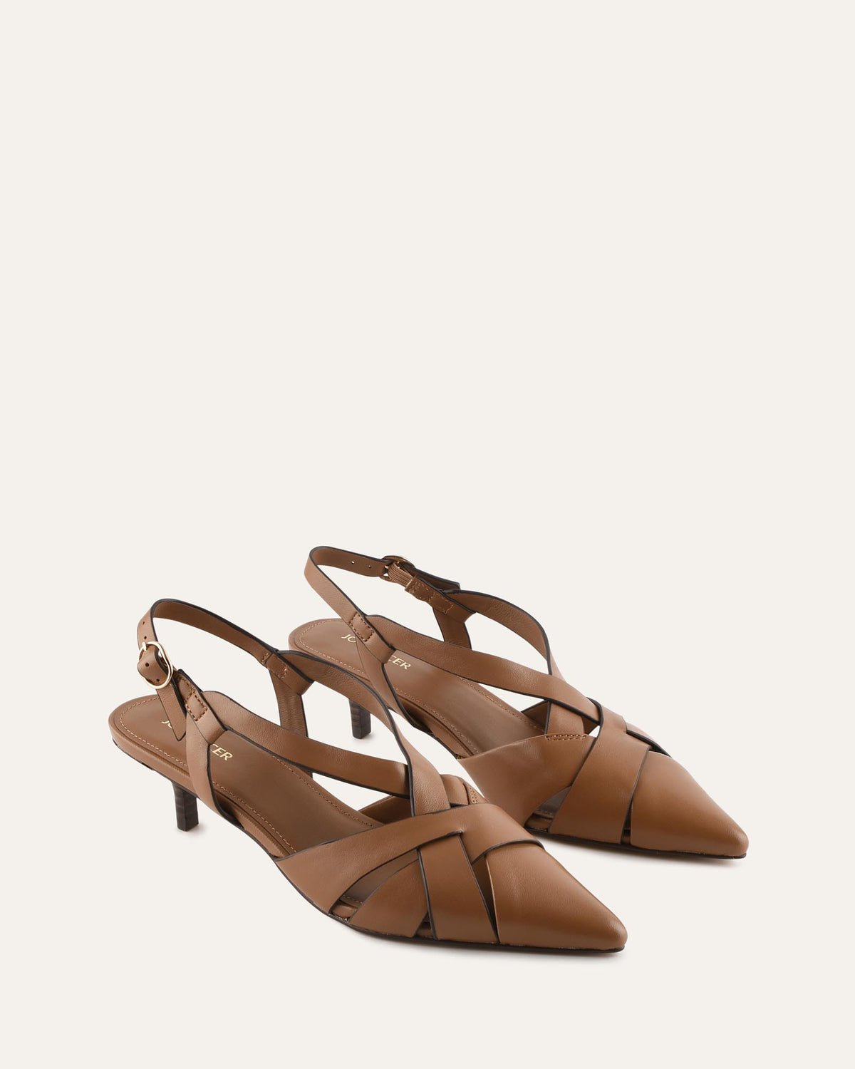A pair of women's pointed-toe slingback sandals in tan leather, featuring criss-crossing straps across the instep and a low kitten heel, shown against a plain off-white background.