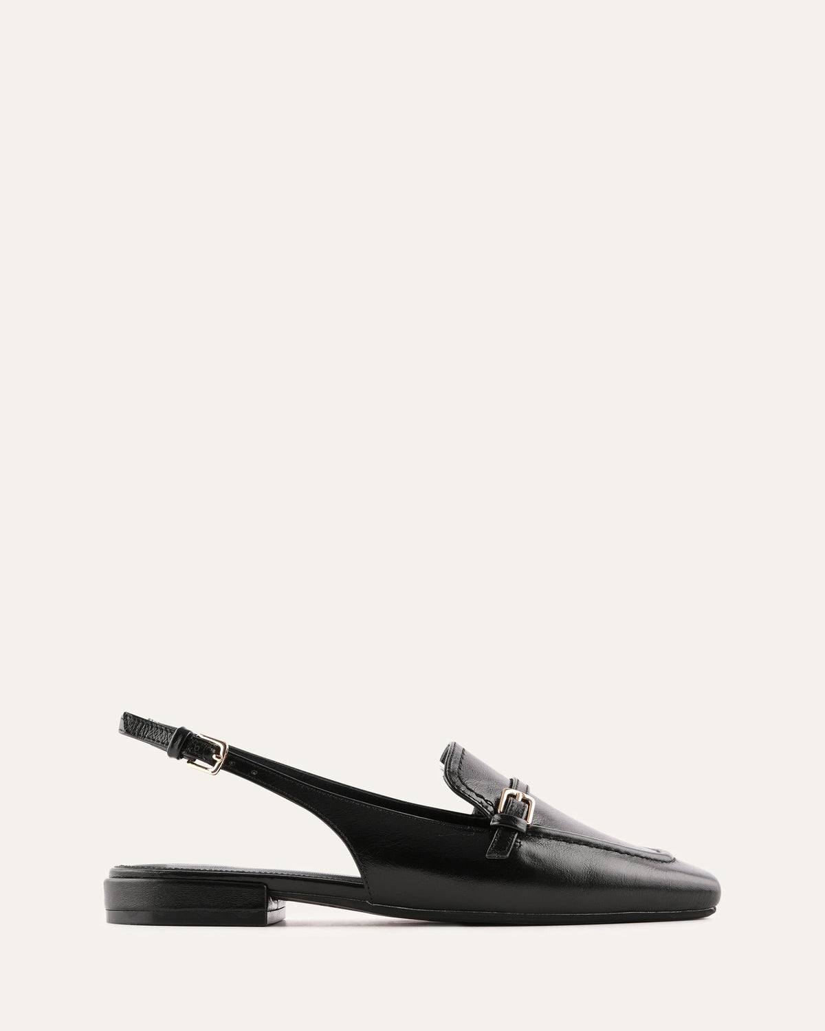 Black loafer with a slingback design on a white background
