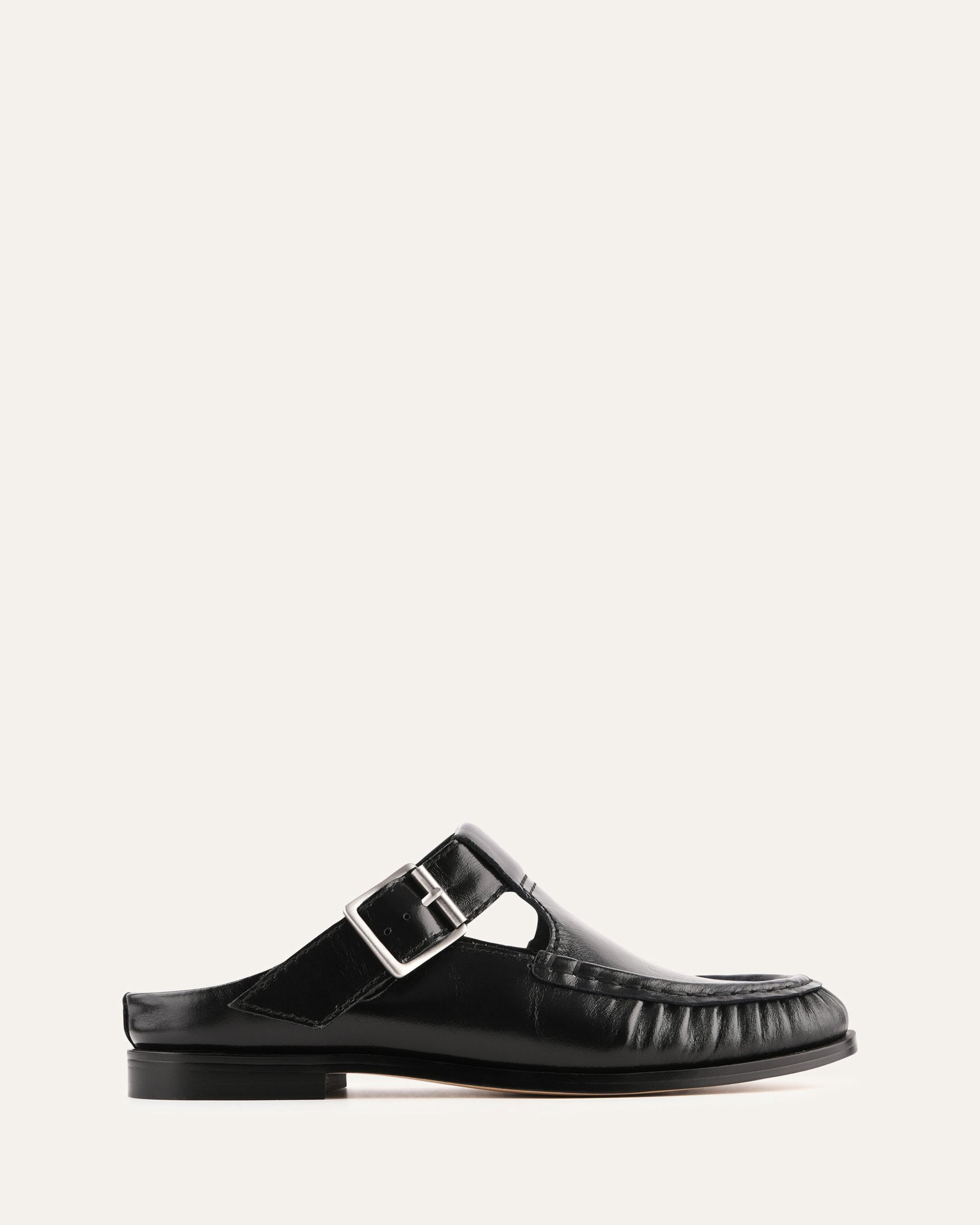 Black sandal with a buckle on a white background