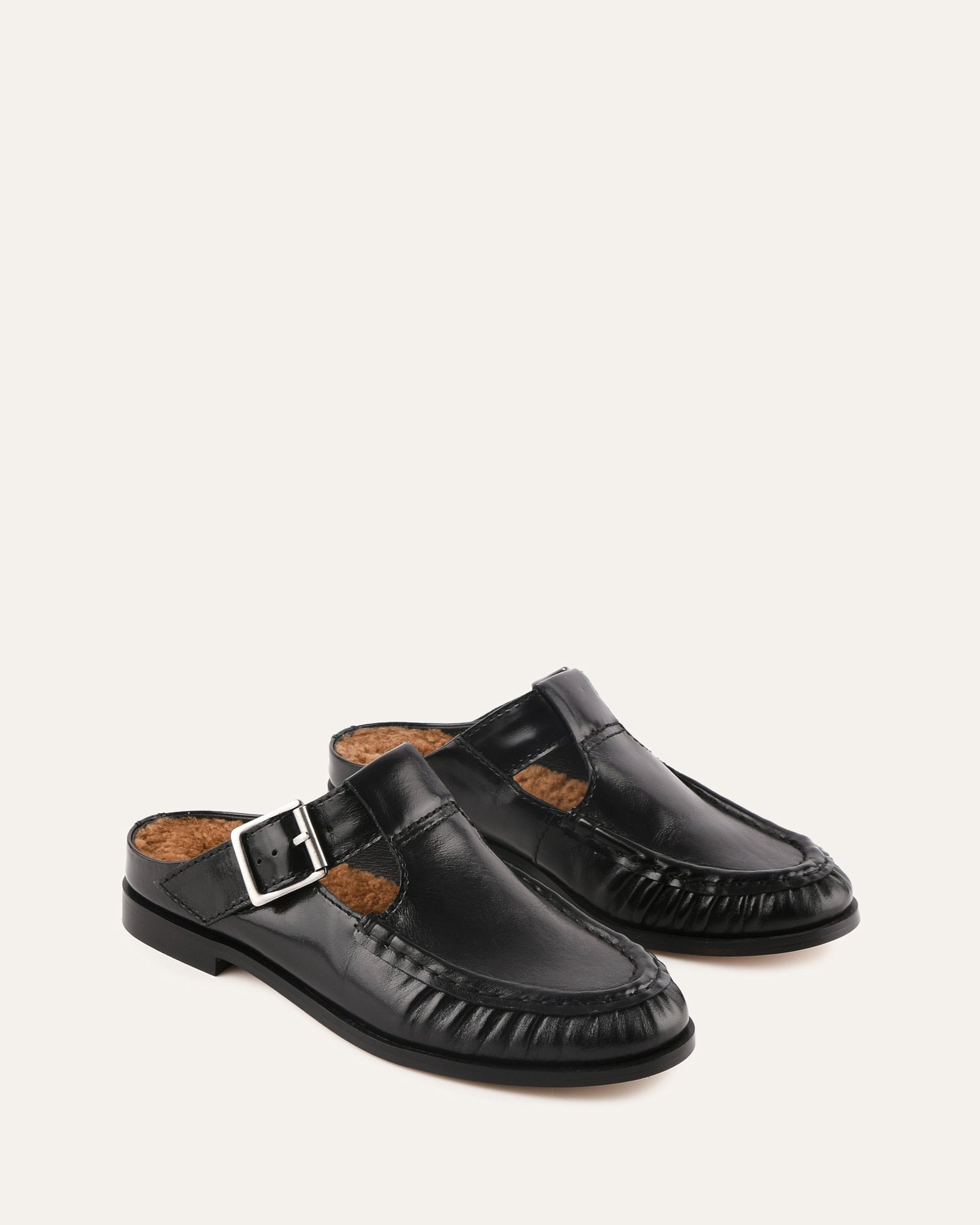 Black sandal with a buckle on a white background