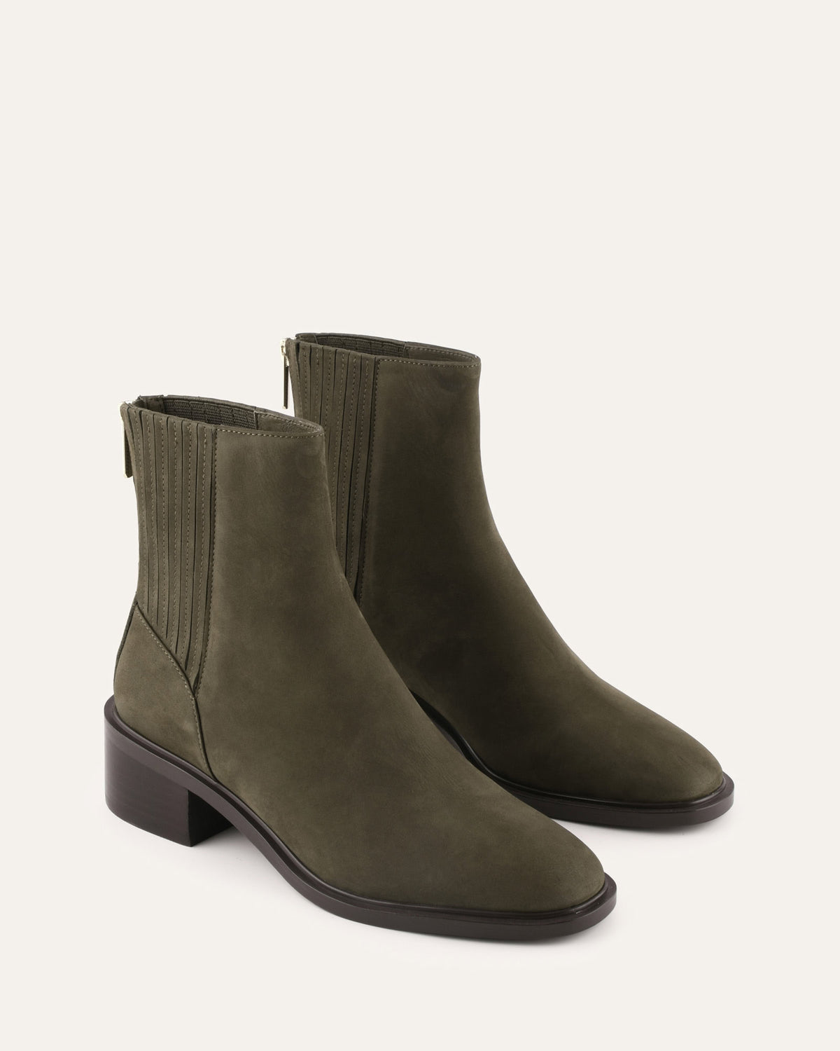 Pair of green ankle boots on a white background