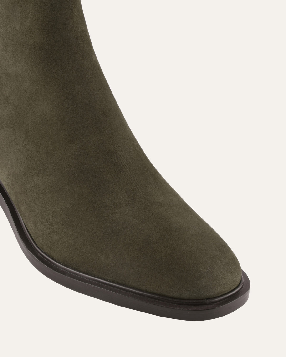 Green suede boot on a white background