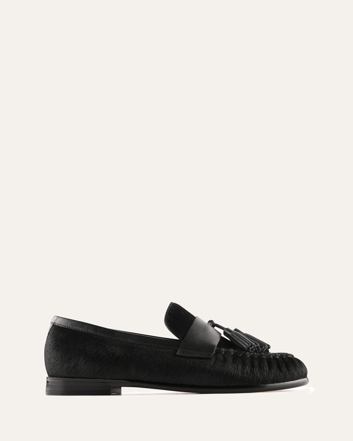 Black loafer shoe on a light gray background