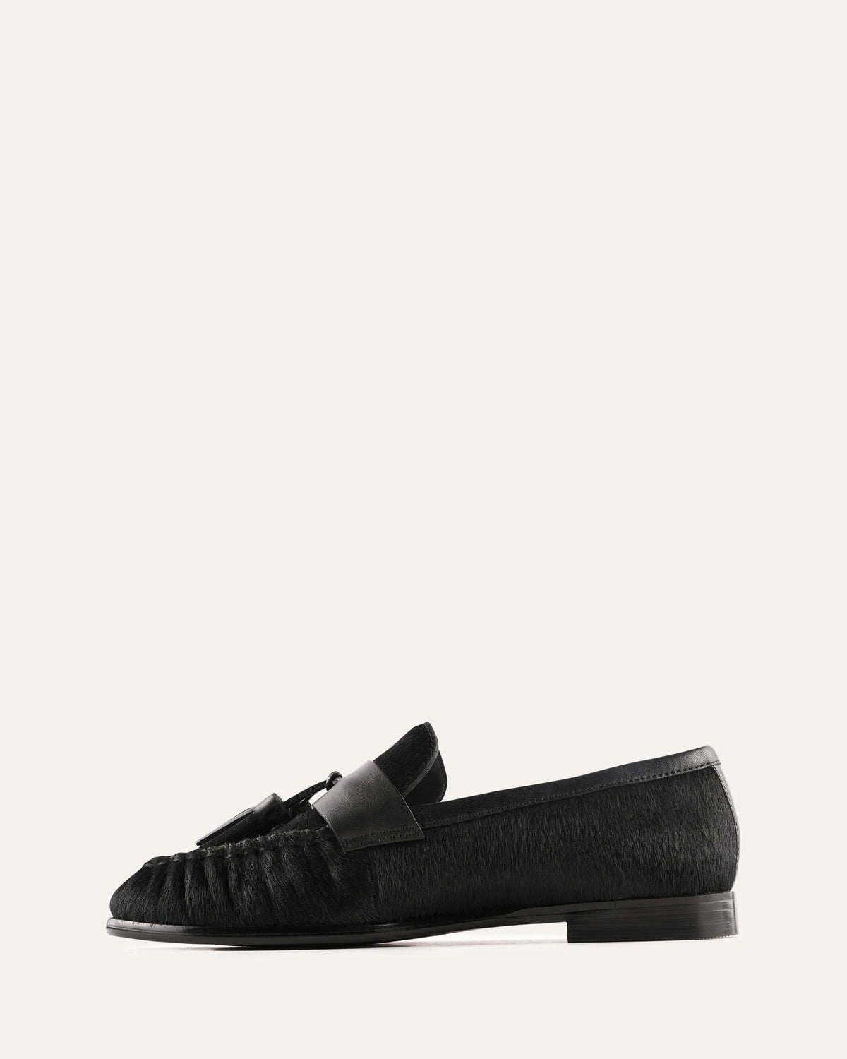 Black loafers on a light gray background