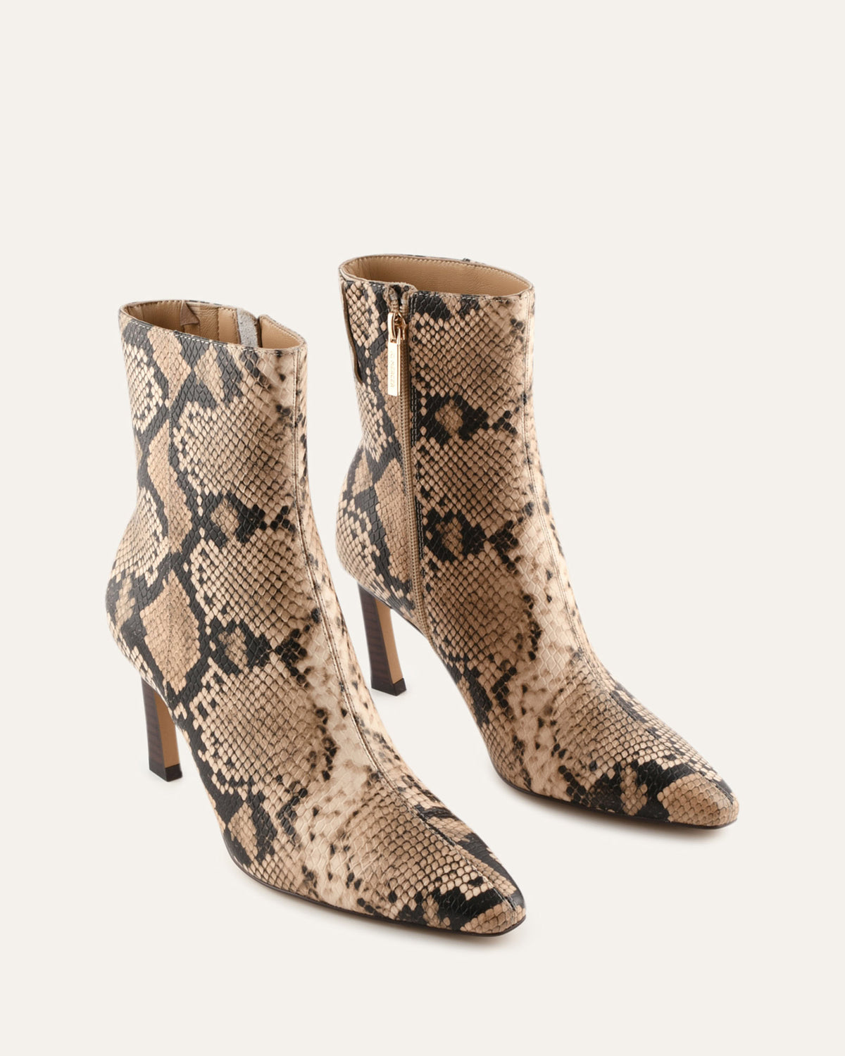Snake print ankle boots on a white background