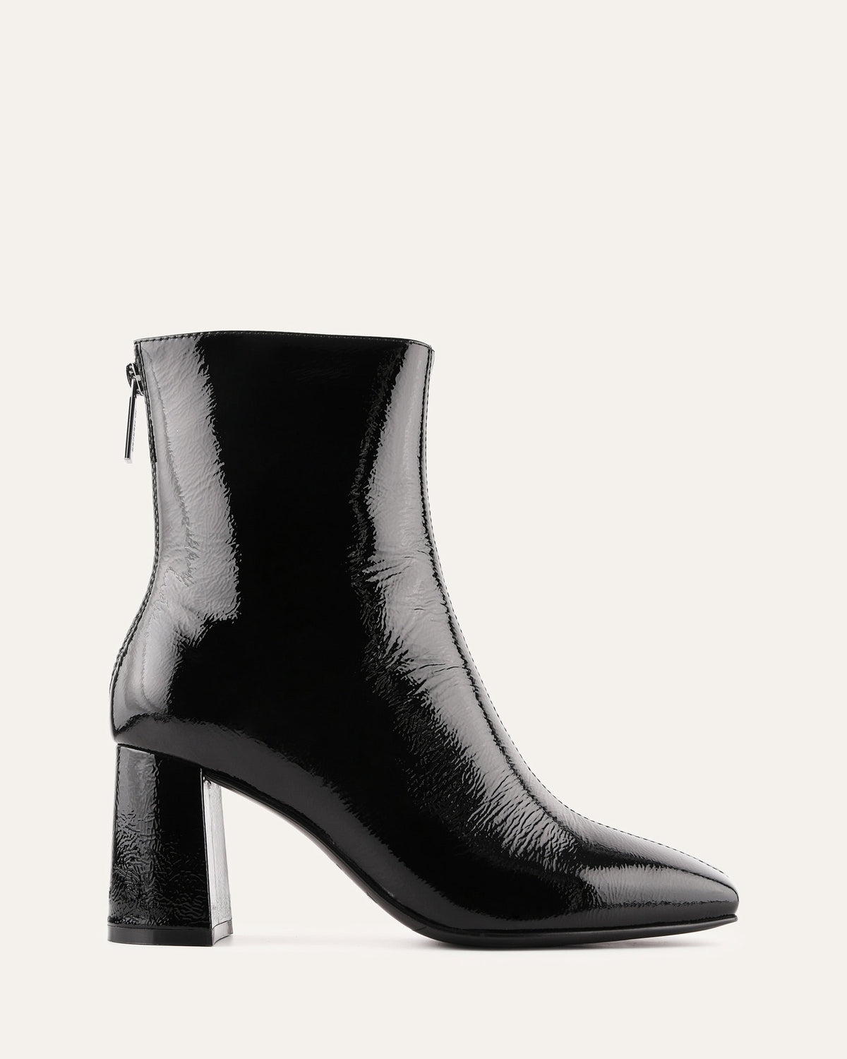 Black patent leather ankle boot on a white background