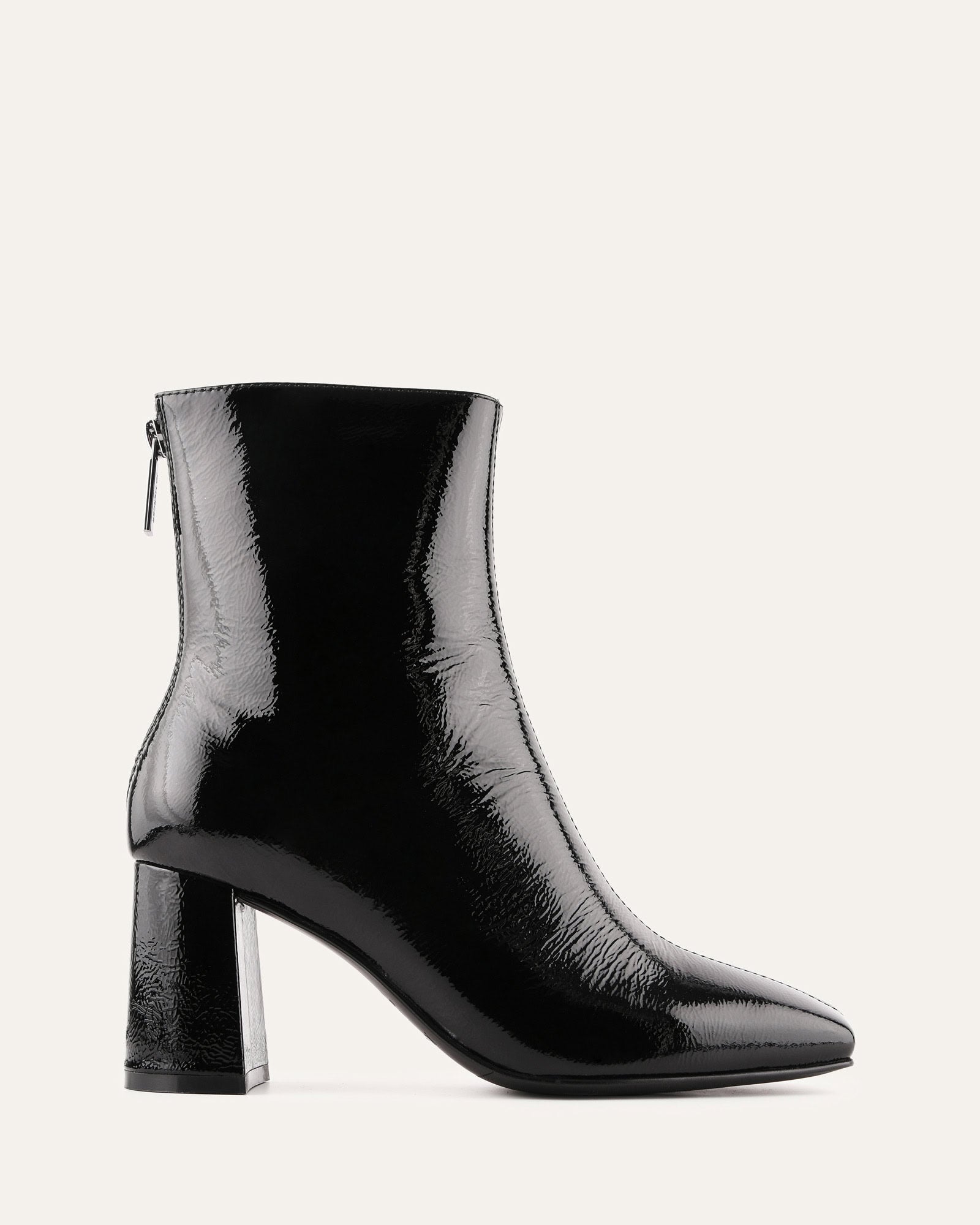 Black patent leather ankle boot on a white background