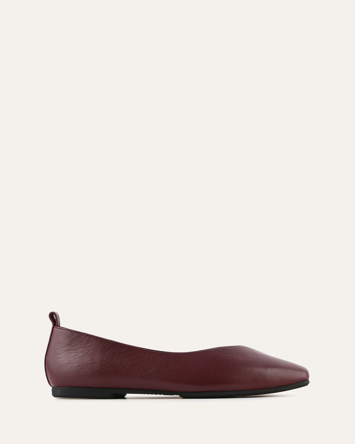 Maroon flat shoe on a white background