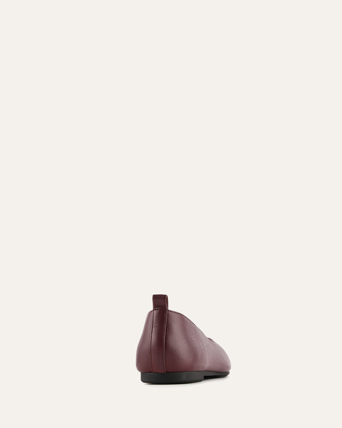 Maroon leather shoe on a light gray background