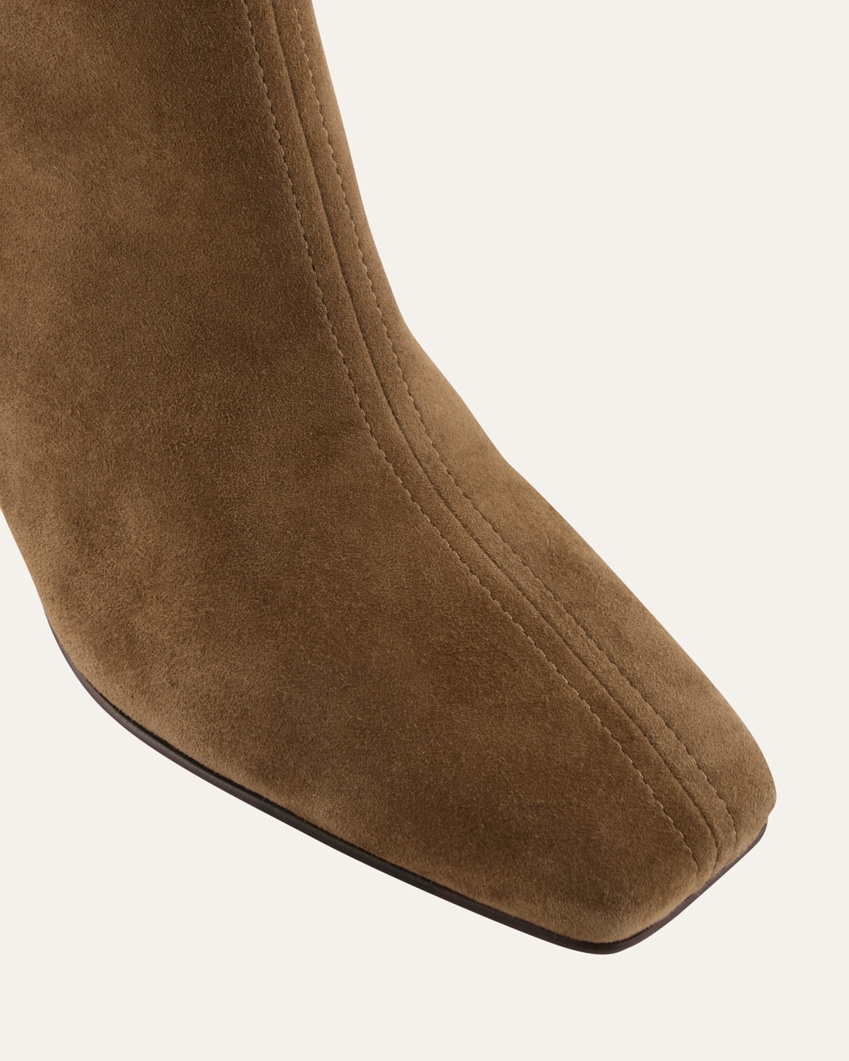 Brown suede knee-high boot on a white background