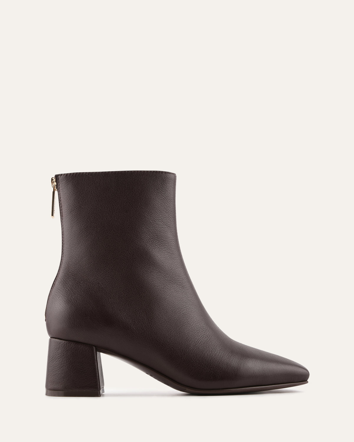 Black ankle boot on a light gray background