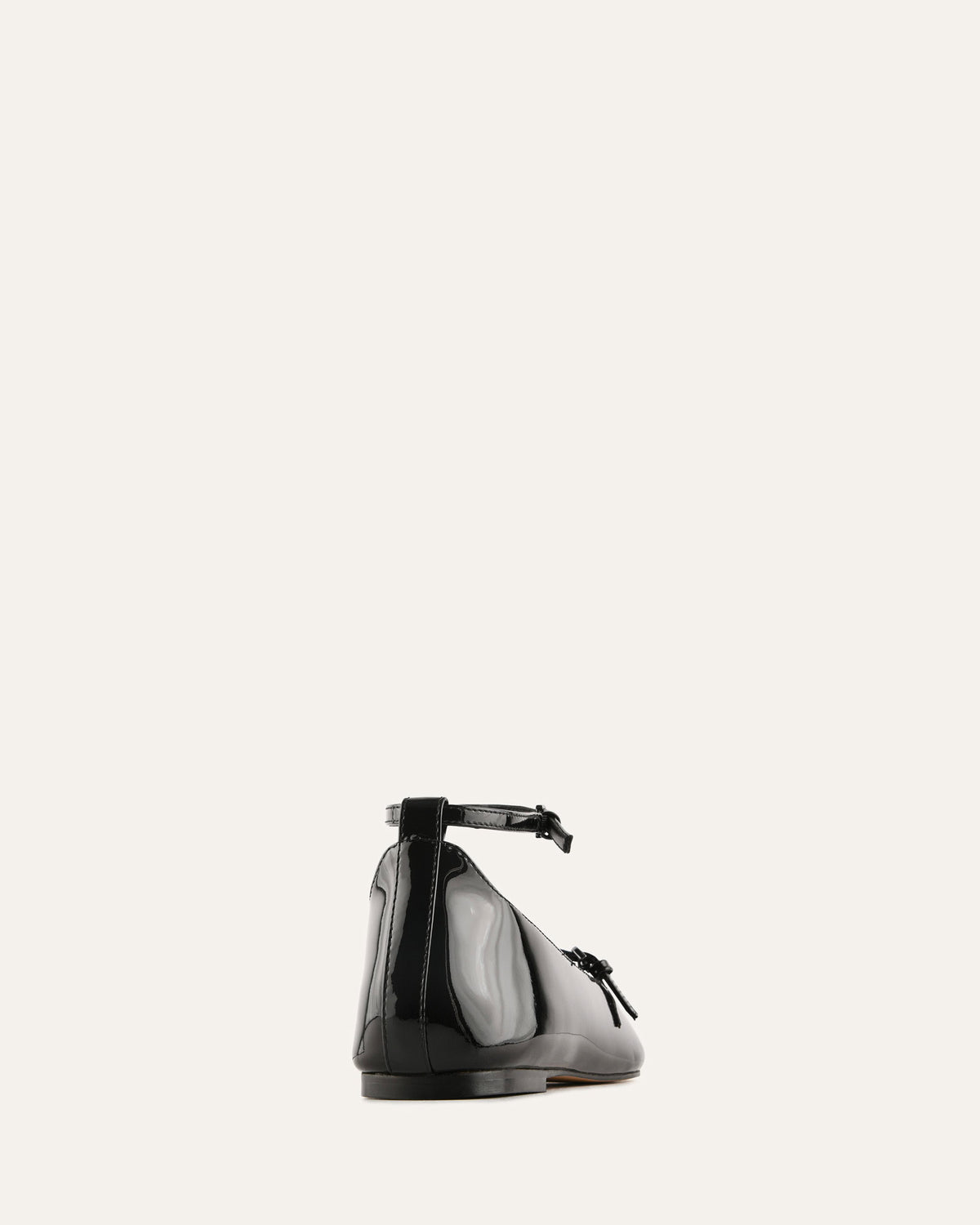 Black shoe with a bow on a white background